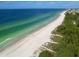 Aerial view of pristine beach with calm, clear water at 4204 126Th W St # 506, Cortez, FL 34215