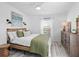 Bright bedroom with wood-look floors and a comfy bed at 4204 126Th W St # 506, Cortez, FL 34215