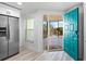 Inviting entryway with teal door and access to a balcony at 4204 126Th W St # 506, Cortez, FL 34215