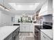 Modern kitchen with white cabinets, quartz countertops, and stainless steel appliances at 4204 126Th W St # 506, Cortez, FL 34215