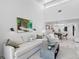 Bright living room with comfy sofa, stylish coffee table, and view into dining area at 4204 126Th W St # 506, Cortez, FL 34215