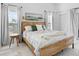 Spacious main bedroom with a king-size bed and access to a balcony at 4204 126Th W St # 506, Cortez, FL 34215