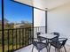 Enjoyable screened balcony with table and chairs, offering views of nature at 4204 126Th W St # 506, Cortez, FL 34215