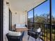 Private screened balcony with outdoor seating and tranquil garden views at 4204 126Th W St # 506, Cortez, FL 34215