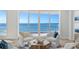 Spacious living room with panoramic ocean view and comfortable seating at 455 Longboat Club Rd # 504, Longboat Key, FL 34228