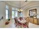 Elegant dining room with a large table and chairs, and a beautiful chandelier at 4911 96Th St E, Bradenton, FL 34211