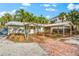 Single story home with carport and tropical landscaping at 5019 Commonwealth Dr, Sarasota, FL 34242