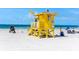 Sunny beach scene featuring a lifeguard stand, clear blue skies, and the ocean's inviting horizon at 5019 Commonwealth Dr, Sarasota, FL 34242
