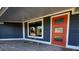 Modern entryway with a vibrant orange door and updated flooring at 506 Treasure Boat Way, Sarasota, FL 34242