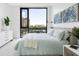 Bedroom with light blue bedding and large windows with city views at 509 Golden Gate Pt # 3, Sarasota, FL 34236