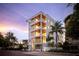 Modern white building with balconies and palm trees, showcasing luxurious design at 509 Golden Gate Pt # 3, Sarasota, FL 34236