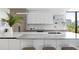 Modern kitchen with white cabinetry, marble countertops, and high-end appliances at 509 Golden Gate Pt # 3, Sarasota, FL 34236