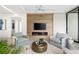 Living room with a wood wall, fireplace, and comfortable seating at 509 Golden Gate Pt # 3, Sarasota, FL 34236