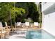 Refreshing pool with wooden lounge chairs and lush greenery at 509 Golden Gate Pt # 3, Sarasota, FL 34236