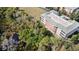 Aerial view of a large apartment building with a green roof and balconies at 5209 Manorwood Dr # 3A, Sarasota, FL 34235