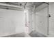 Open basement storage area with exposed pipes and access to laundry at 5209 Manorwood Dr # 3A, Sarasota, FL 34235