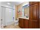 Bathroom with wood cabinets, white tile, and a bathtub at 5209 Manorwood Dr # 3A, Sarasota, FL 34235