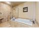 Bathroom with soaking tub and a walk-in shower with tile surround at 5209 Manorwood Dr # 3A, Sarasota, FL 34235