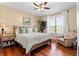 Bedroom with hardwood floors, a king-size bed, and a comfy armchair at 5209 Manorwood Dr # 3A, Sarasota, FL 34235