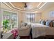 Bright bedroom featuring a king-size bed and private balcony at 5209 Manorwood Dr # 3A, Sarasota, FL 34235