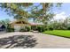 House exterior showcasing a landscaped yard and brick driveway at 5209 Manorwood Dr # 3A, Sarasota, FL 34235