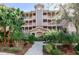 Three-story condo building with landscaped grounds and walkway at 5209 Manorwood Dr # 3A, Sarasota, FL 34235