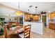 Kitchen with breakfast bar, granite counters, and view to living area at 5209 Manorwood Dr # 3A, Sarasota, FL 34235