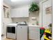 Laundry room with washer, dryer, cabinets, and a utility sink at 5209 Manorwood Dr # 3A, Sarasota, FL 34235