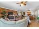 Living room with wood accent wall and curved sectional sofa at 5209 Manorwood Dr # 3A, Sarasota, FL 34235
