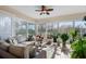 Bright sunroom with wicker furniture, large windows, and potted plants at 5209 Manorwood Dr # 3A, Sarasota, FL 34235