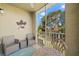 Screened balcony with wicker chairs and a metal table at 5601 Bentgrass Dr # 10-112, Sarasota, FL 34235