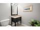Bathroom featuring a toilet, vanity with granite counters, framed mirror, and stylish decor at 5601 Bentgrass Dr # 10-112, Sarasota, FL 34235