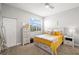 Bright bedroom with sunny yellow accents, carpet and closet space at 5601 Bentgrass Dr # 10-112, Sarasota, FL 34235