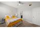 Bright bedroom featuring a queen bed, ceiling fan, and ensuite bathroom at 5601 Bentgrass Dr # 10-112, Sarasota, FL 34235