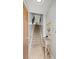 Hallway with a stairway leading to the upper floors, and a console table at 5601 Bentgrass Dr # 10-112, Sarasota, FL 34235