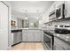 Updated kitchen featuring stainless steel appliances, granite counters, and ample cabinet space at 5601 Bentgrass Dr # 10-112, Sarasota, FL 34235