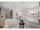 Open-concept living space with a balcony, modern furniture, and granite countertops at 5601 Bentgrass Dr # 10-112, Sarasota, FL 34235