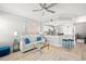 Living room with white couch, kitchen bar, and blue accents at 5601 Bentgrass Dr # 10-112, Sarasota, FL 34235