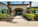 Community clubhouse entrance with a nicely landscaped walkway at 5652 Semolino St, Nokomis, FL 34275