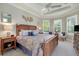 Spacious main bedroom with a king-size bed and plantation shutters at 5652 Semolino St, Nokomis, FL 34275