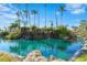 Community pond with a waterfall feature and tropical landscaping at 5855 Midnight Pass Rd # 511, Sarasota, FL 34242