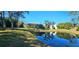 Landscaped backyard with pond views and lush greenery at 5868 Meriwether Pl, Sarasota, FL 34232