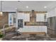 Updated kitchen with white cabinets, granite countertops, and stainless steel appliances at 5868 Meriwether Pl, Sarasota, FL 34232