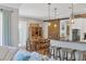 Modern kitchen with a large island, wooden dining table, and stylish pendant lighting at 5868 Meriwether Pl, Sarasota, FL 34232