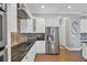 Modern kitchen with stainless steel appliances and granite countertops at 5868 Meriwether Pl, Sarasota, FL 34232
