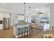 Open kitchen boasts a large island with seating and stainless steel appliances at 5868 Meriwether Pl, Sarasota, FL 34232