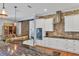 Modern kitchen with white cabinets, granite countertops, and a large island at 5868 Meriwether Pl, Sarasota, FL 34232