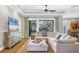 Spacious living room featuring a large sectional sofa and a view of the backyard at 5868 Meriwether Pl, Sarasota, FL 34232