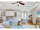 Open concept living room with a large sectional and access to the entryway at 5868 Meriwether Pl, Sarasota, FL 34232