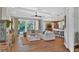 Open living area with comfy sectional sofa, wood floors, and access to a pool at 5868 Meriwether Pl, Sarasota, FL 34232